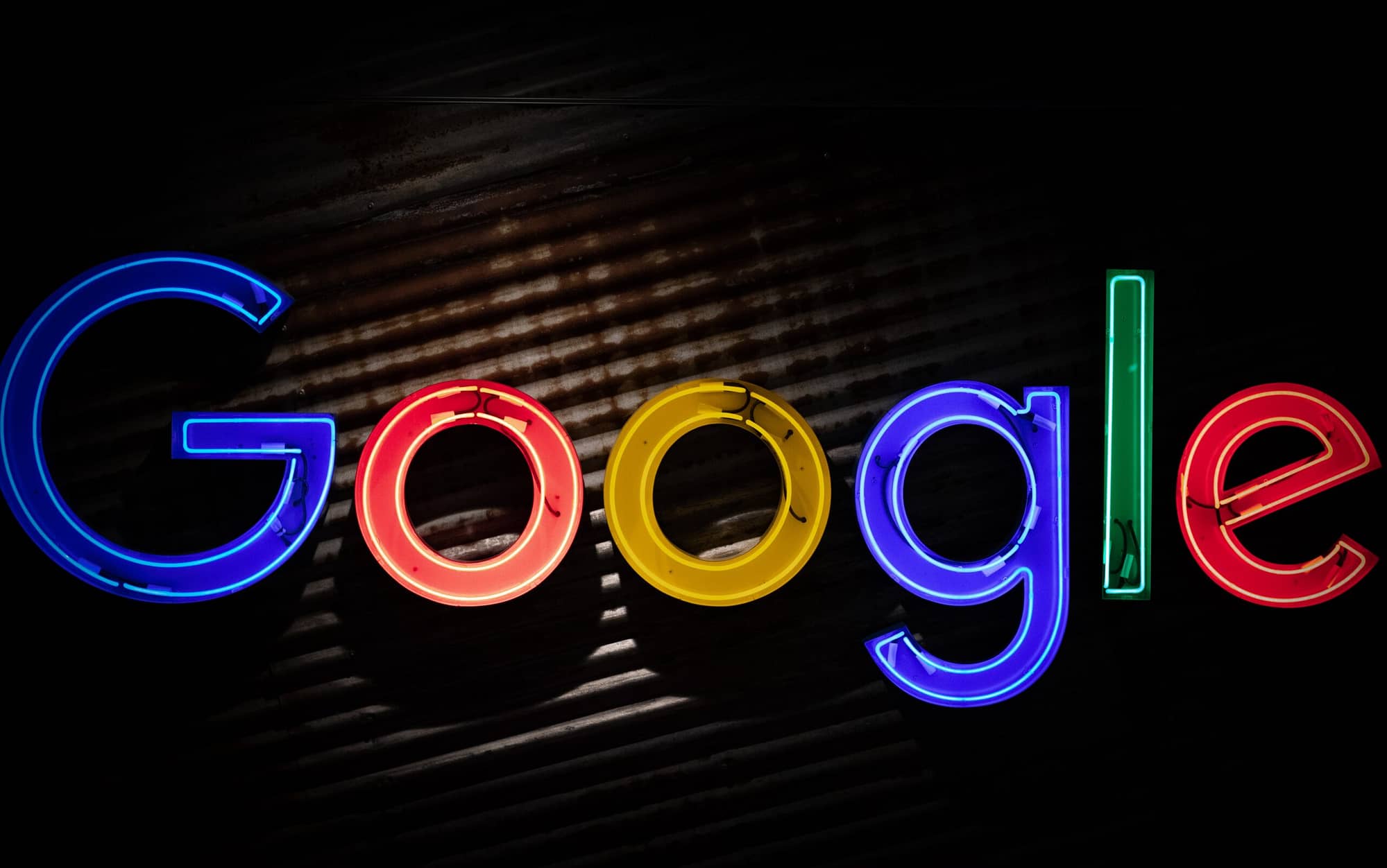 Image of the Google logo in neon lights against a dark background